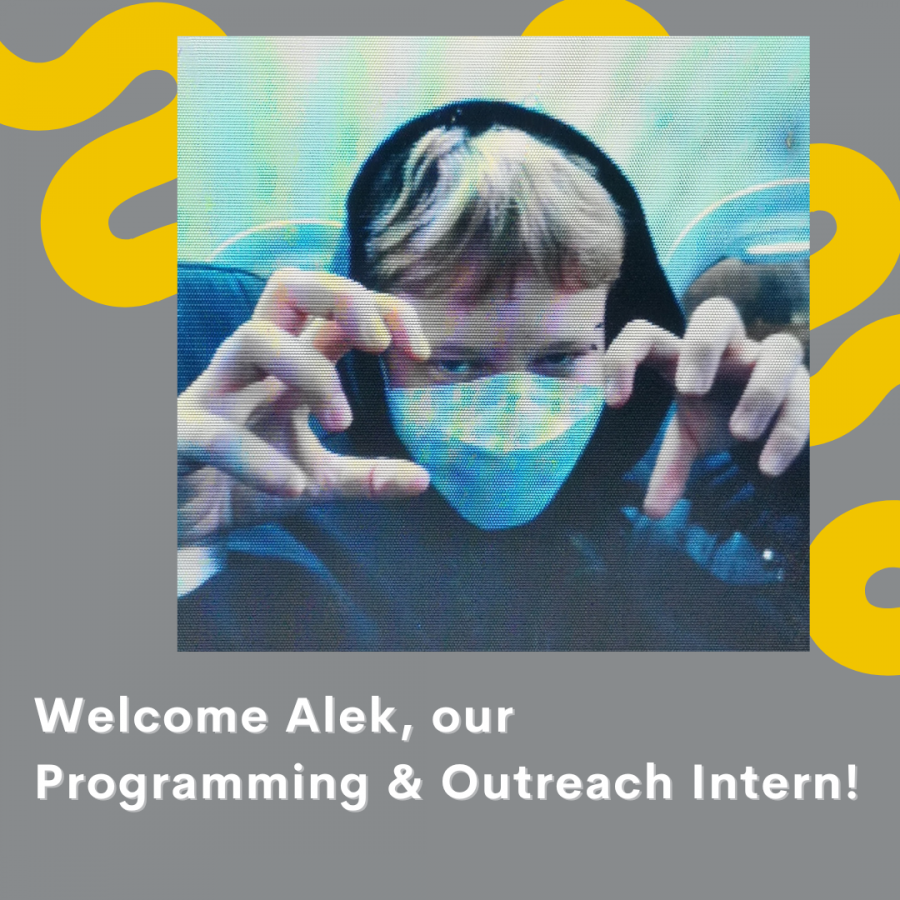 Plain grey background with a thick, squiggly yellow line running from the top left corner to the lower right side. In the foreground to the top right is a picture of Alek. Alek is a person with blonde hair wearing a white mask and a black hooded sweatshirt with the hood up. He is jokingly making a scary face with his hands up like claws. White text at the bottom left of the image reads "Welcome Alek, our Programming and Outreach Intern!"