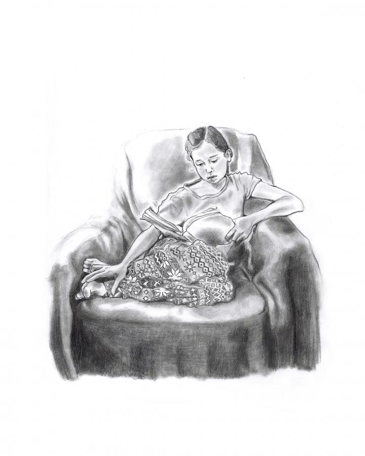 ID: A black and white pencil drawing set against a white page of a young girl who sits curled into a large armchair, absorbed in a book. The girl is wearing a plain t-shirt as well as a long skirt featuring geometric patterns. 